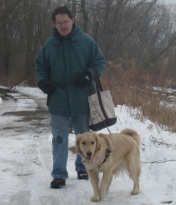 Golden Retriever and Man walking in the snow