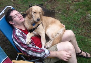 Golden Retriever sitting on man's lap