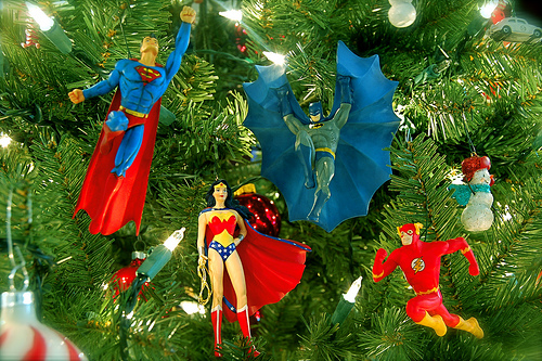 Superman, Batman, Wonder Woman and Flash guard a Christmas tree.