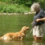 Pam and her dog save money by exercising in the creek.