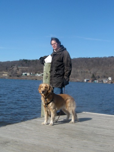 Honey the golden retriever walks the pier on Cayuga Lake.