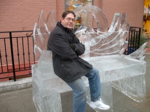 Man sitting on ice bench.