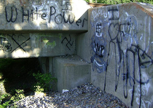 Racist graffiti under a bridge.
